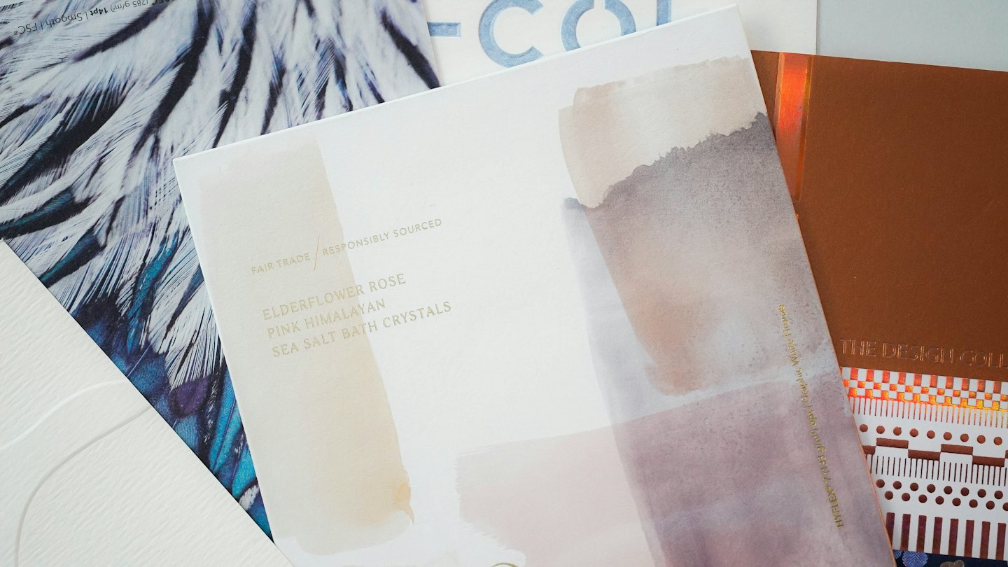 Samples of textured paper and card stock with watercolor swatches.